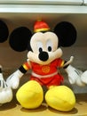 Mickey Mouse - shaped stuffed animals are displayed on the shelves, looking very cute