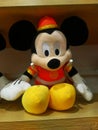 Mickey Mouse - shaped stuffed animals are displayed on the shelves, looking very cute