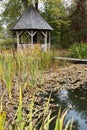 The late-renaissance Kalnoky castle, Miclosoara. Garden, pond, gazebo. Royalty Free Stock Photo