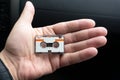 Micro audio cassette on hand background cut Royalty Free Stock Photo