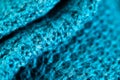 Micro close up of blue crocheted woolly fabric with copy space