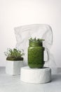 Micro-green smoothies and micro-greens stand on white concrete podiums.