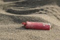 Corroded Plastic lighter trash on sandy sea ecosystem,microplastics sea coast pollution Royalty Free Stock Photo