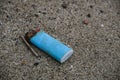 Salt Corroded Plastic lighter trash on sandy sea ecosystem,microplastics sea coast pollution Royalty Free Stock Photo