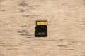 Micro SD card back side close up shot on a wooden surface. Action camera accessories and memory card. Memory card close up shot on Royalty Free Stock Photo