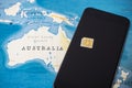 Micro SIM card and smartphone on the world map Royalty Free Stock Photo