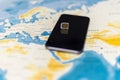 Micro SIM card and smartphone on the world map Royalty Free Stock Photo