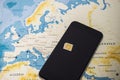 Micro SIM card and smartphone on the world map Royalty Free Stock Photo