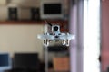 Micro spy drone flying inside a house. Remote controlled nano air vehicle with a small camera