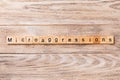 Microaggressions word written on wood block. Microaggressions text on wooden table for your desing, concept