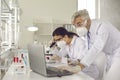 Microbiologist biotechnology researcher in facial mask conducting experiment