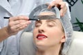 Microblading. Permanent makeup. Attractive woman getting facial care and tattoo Royalty Free Stock Photo
