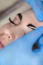 Microblading, micropigmentation eyebrows work flow in a beauty salon. Woman having her eye brows drawn and tinted. Semi-permanent