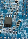 Microchip and components on blue electronic pcb closeup Royalty Free Stock Photo