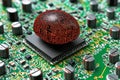 Microchip embedded glowing red brain design set on circuit board representing AI powered technology advanced neural computing