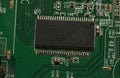 Microchip on green electronic pcb closeup Royalty Free Stock Photo