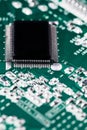 Microchip integrated on green motherboard computer science Royalty Free Stock Photo