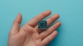 Microchip resting on a human hand against blue background Royalty Free Stock Photo