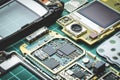 Microchips, semiconductor components and precious metals on the Board of the disassembled old mobile phone close-up