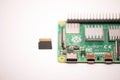 Microcomputer Raspberry Pi 4 with a microsd card lying next to it, ready to use for its intended purpose Royalty Free Stock Photo