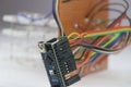 Microcontroller board connects to an electronic project, Programmable microcontroller board projects showing concept of the Royalty Free Stock Photo