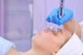 Microcurrent face treatment with hyaluronic acid gel for young woman, closeup. Royalty Free Stock Photo