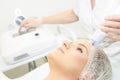 Microcurrent facial dermatology procedure. Model. Aesthetic radiofrequency treatment. Micro current cosmetology massage