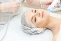 Microcurrent facial dermatology procedure. Model. Aesthetic radiofrequency treatment. Micro current cosmetology massage