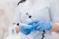 Doctor holds microcurrent therapy device in his hands