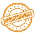 MICROECONOMICS text on orange grungy round rubber stamp
