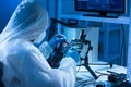 Microelectronics engineer works in a modern scientific laboratory on computing systems and microprocessors. Electronic