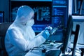 Microelectronics engineer works in a modern scientific laboratory on computing systems and microprocessors. Electronic