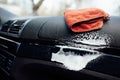 Microfiber cloth and foam on a car cockpit. Auto clean concept