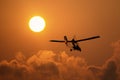 Microlight aircraft with two passengers with the sun and cloud Royalty Free Stock Photo