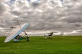 Microlite and planes on a grass field Royalty Free Stock Photo