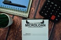 Microloan write on a paperwork isolated on office desk