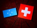 Micronesian flag with Swiss flag on a tree stump isolated