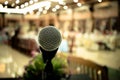 Microphone on abstract blurred of front podium and speech in seminar room or speaking conference hall light, Event meeting