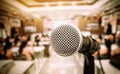 Microphone on abstract blurred of front podium and speech in seminar room or speaking conference hall light, Event meeting Royalty Free Stock Photo