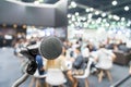 Microphone with abstract blurred photo of conference hall or seminar room with attendee and bokeh, Business meeting concept