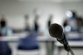 Microphone on the abstract blurred photo of seminar room background Royalty Free Stock Photo