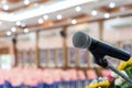 Microphone on abstract blurred of speech in seminar room or speaking conference hall light on stage with flower, Event Background Royalty Free Stock Photo