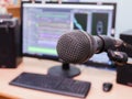 Microphone on the background of the computer monitor. Home recording Studio. Close-up. The focus in the foreground