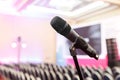 Microphone on the background of rows of chairs in the hall
