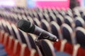 Microphone on the background of rows of chairs in the hall