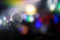 Microphone on a black background with colorful lights and flares