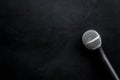 Microphone for blogger, journalist or musician work on black background top view mock-up