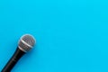 Microphone for blogger, journalist or musician work on blue background top view mock-up