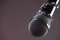 Microphone with a chain, depicting the idea of freedom of the press or freedom of expression on dark background. World press