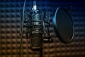 Microphone close - up on the background of a professional recording Studio. Workplace singers and musicians. Microphone stand for